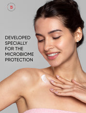 Woman applying cream to her shoulder with text about microbiome protection on a gray background