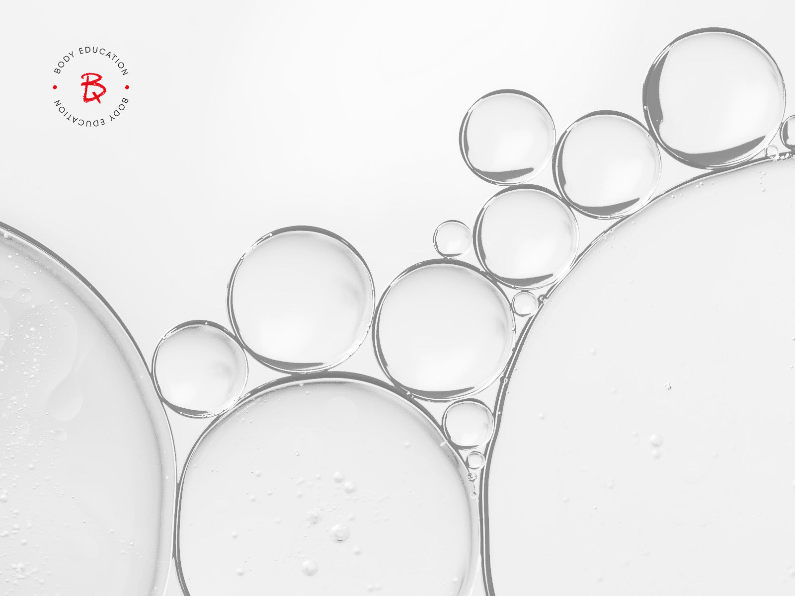 Close-up of bubbles on a white background with BODIQ brand logo in the corner.

